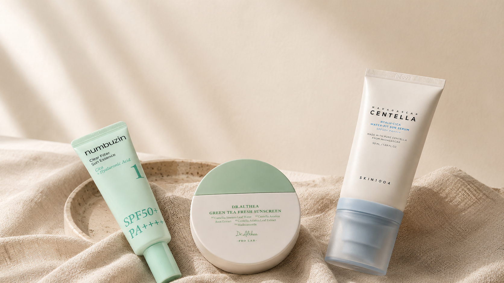 Three Korean sunscreens — Numbuzin Clear Filter Sun Essence, Dr. Althea Green Tea Fresh Sunscreen, and SKIN1004 Hyalu-Cica Water-Fit Sun Serum